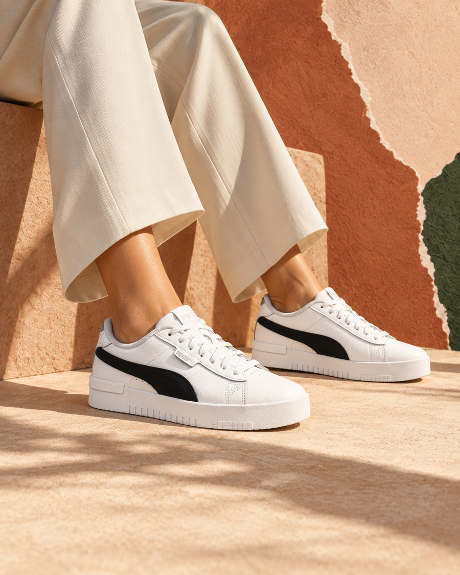White Puma trainers with ivory tailoring in a warm clay editorial setting
